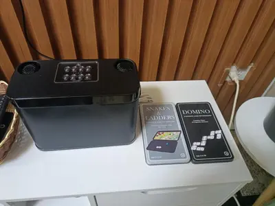 a black appliance sitting on top of a white table at Casiana Place Staycation at Shore2 Residences in Manila