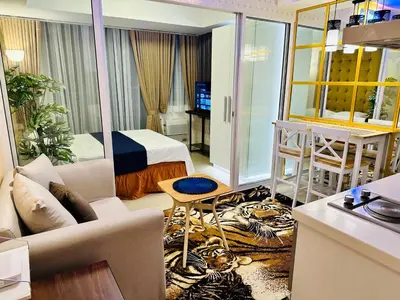 a living room with a bed and a living room with a couch at We Vibe, Azure Urban Resort Residences in Manila