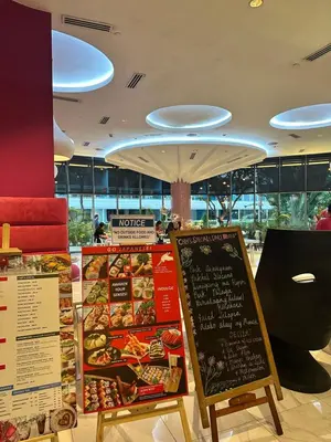 a restaurant with a menu of food on display at We Vibe, Azure Urban Resort Residences in Manila