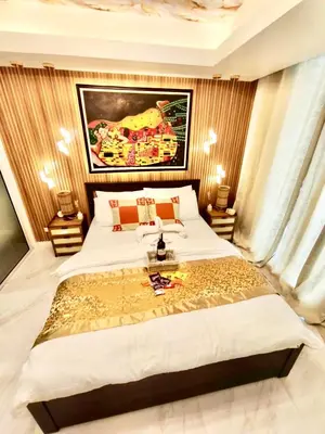 a bedroom with a large white bed in a room at Miami Suites in Manila