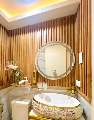 a bathroom with a tub and a large mirror at Miami Suites in Manila