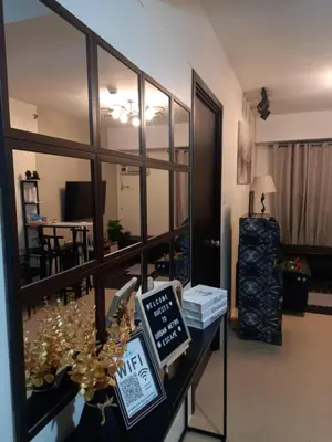 a view of a living room with a table with books at Urban Metro Escape in Pasig City in Manila