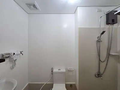 a bathroom with a shower and a toilet and a sink at 1BR Condotel with Balcony at SM Light Residences #LT12 in Manila