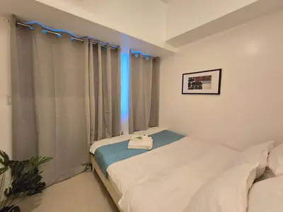a small bedroom with a bed and a window at 1BR Condotel with Balcony at SM Light Residences #LT12 in Manila