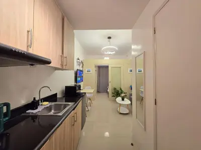 a kitchen with a sink and a counter top at 1BR Condotel with Balcony at SM Light Residences #LT12 in Manila