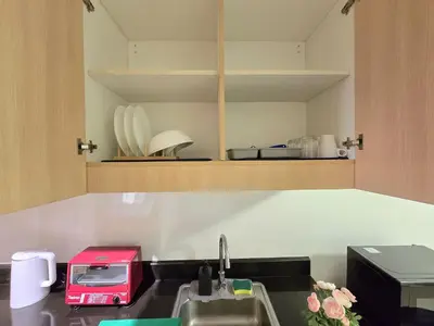 a kitchen with a sink and a toaster on a counter at 1BR Condotel with Balcony at SM Light Residences #LT13 in Manila