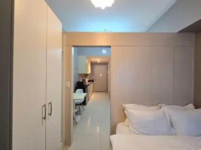 a bedroom with a bed and a dining room at 1BR Condotel with Balcony at SM Light Residences #LT13 in Manila