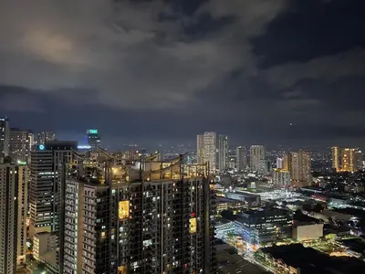 a view of a city at night at 1BR Condotel with Balcony at SM Light Residences #LT13 in Manila
