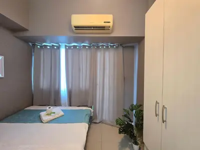 a small room with a bed and a window at 1BR Condotel with Balcony at SM Light Residences #LT13 in Manila