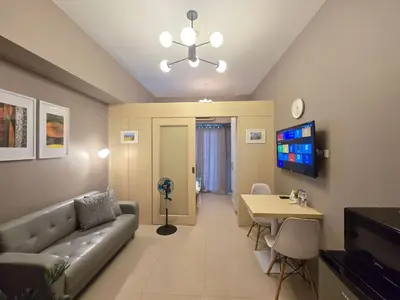 a living room with a couch and a table at 1BR Condotel with Balcony at SM Light Residences #LT13 in Manila