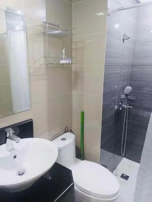 a bathroom with a toilet and a sink and a shower at Jennie's Lucky 5M Suite in Manila
