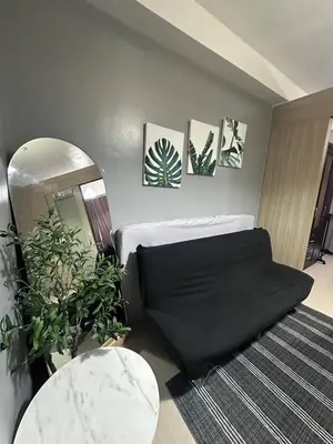 a living room with a bed and a mirror at Shore Residences Cozy oasis by Richnells Tower D in Manila