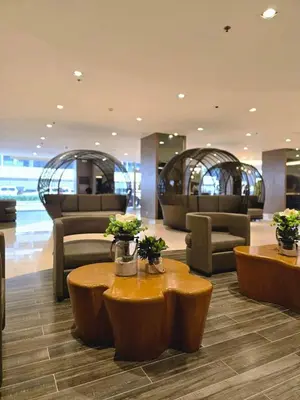 a lobby with couches and tables in a building at Shore Residences Cozy oasis by Richnells Tower D in Manila