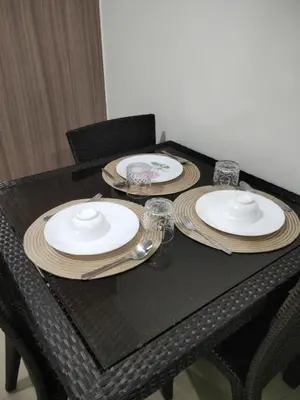 a black table with plates and glasses on it at VSV Luxury Family suits Moa staycation in Manila