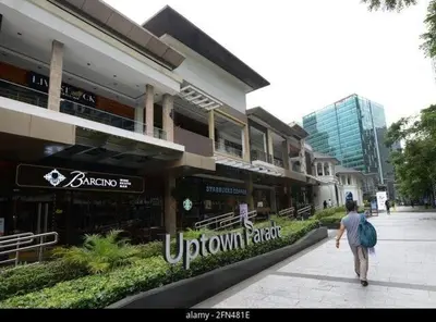 a man walking down a sidewalk in front of a building at LuxeStaysMnl Cozy Japandi Netflx Pool 400mbps in Manila