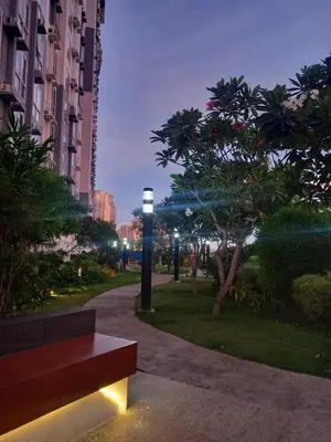 a park with a bench and a street light at night at Spacious Staycation in Pasig Urban Metro Escape in Manila