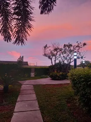 a walkway in a park with a sunset in the background at Spacious Staycation in Pasig Urban Metro Escape in Manila