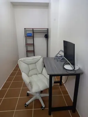 a desk with a chair and a computer on it at Spacious Staycation in Pasig Urban Metro Escape in Manila