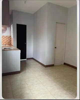 an empty room with a kitchen and a counter at Laureano di trevi tower 2 Condominium Corporation in Manila
