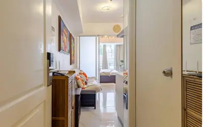 a hallway with a living room with a couch at Miami suites in Manila