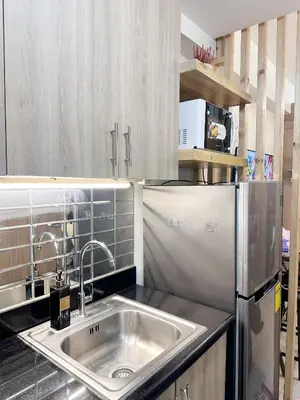 a kitchen with a sink and a refrigerator at 1573 Budget Condo near MOA and Airport in Manila