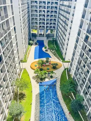 an overhead view of a pool between two tall buildings at 1573 Budget Condo near MOA and Airport in Manila