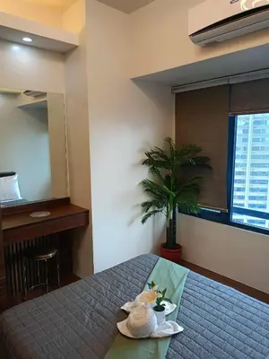 a bedroom with a bed with a stuffed animal on it at 1 bedroom Cozy Escape in Manila