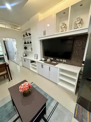 a large living room with a large flat screen tv at White House Staycation by Trixie Datiles in Manila