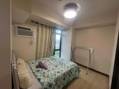 a bedroom with a bed and a window at Gentry Manor Family Room 2 Beds Near Okada MOA NAIA 8E in Manila