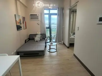 a small room with a bed and a window at Gentry Manor Family Room 2 Beds Near Okada MOA NAIA 8E in Manila