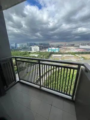 a balcony with a view of a city at Gentry Manor Family Room 2 Beds Near Okada MOA NAIA 8E in Manila