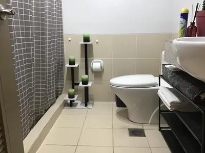 a bathroom with a toilet and a sink at Alea Residences Condominium Casa Hayakawa in Manila