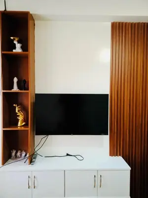 a room with a tv and a white cabinet at Kaunis Hive Hope Residences in Trece Martires