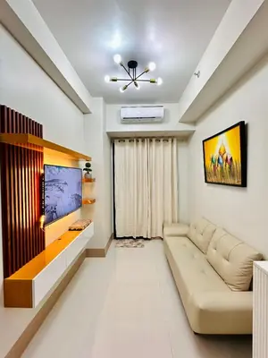 a living room with a couch and a flat screen tv at Claire's place in Manila