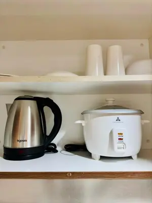 a coffee maker and a toaster on a shelf at Claire's place in Manila