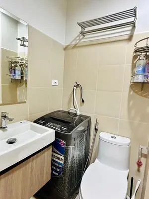 a bathroom with a toilet and a sink at Claire's place in Manila
