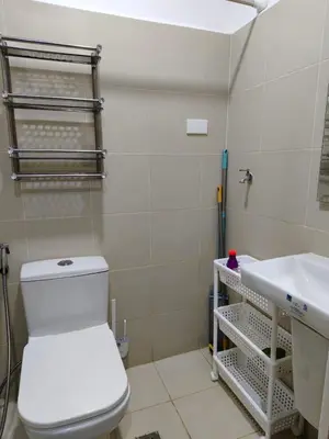 a bathroom with a toilet and a sink at Stylish Condo with City View and Netflix - Pool Access in Manila