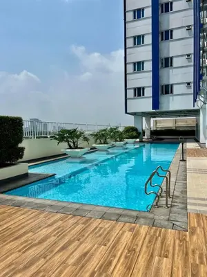 a swimming pool on the roof of a building at Modern Comfort Living! Netflix Ready in Manila