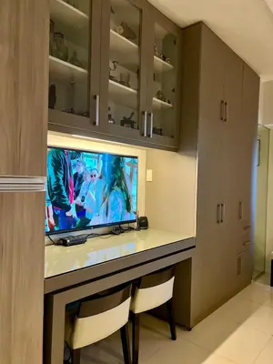 a room with a desk with a television on it at Modern Comfort Living! Netflix Ready in Manila