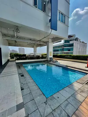 a swimming pool on the side of a building at Modern Comfort Living! Netflix Ready in Manila