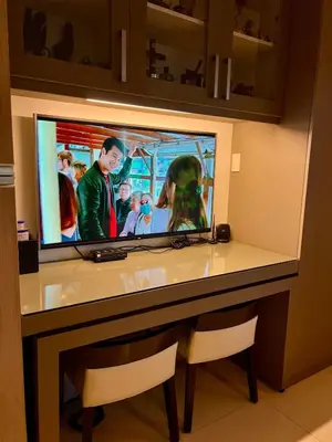 a flat screen tv on a desk in a room at Modern Comfort Living! Netflix Ready in Manila