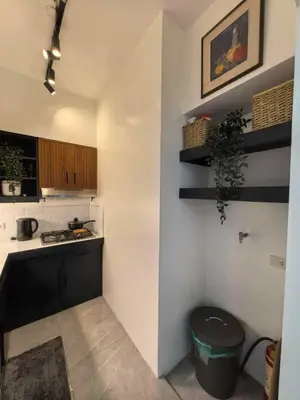 a kitchen with a sink and a counter top at Chelsea Tower 1 in Manila