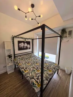 a bedroom with a bed with a canopy at Chelsea Tower 1 in Manila