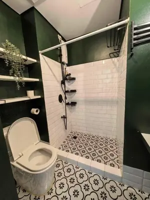 a bathroom with a toilet and a shower at Chelsea Tower 1 in Manila