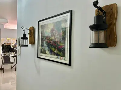 a picture hanging on a wall in a room at A cozy condo within the center of Manila in Manila