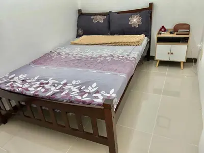 a bedroom with a bed with a purple mattress at A cozy condo within the center of Manila in Manila