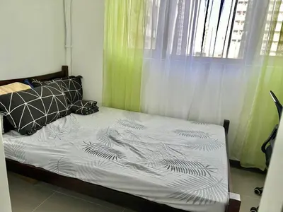 an unmade bed in a room with a window at A cozy condo within the center of Manila in Manila