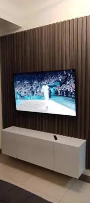 a tv on a wall with a tennis game on it at S-Residence Staycation Near IKEA,MOA,PICC in Manila
