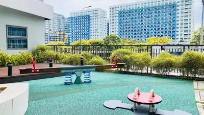 a pool with a playground in a city with tall buildings at S-Residence Staycation Near IKEA,MOA,PICC in Manila