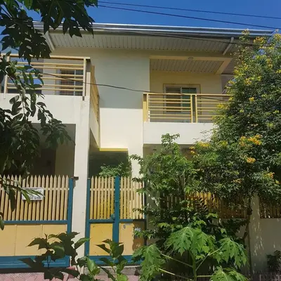 a house with a blue gate in front of it at Fazing in Bacoor